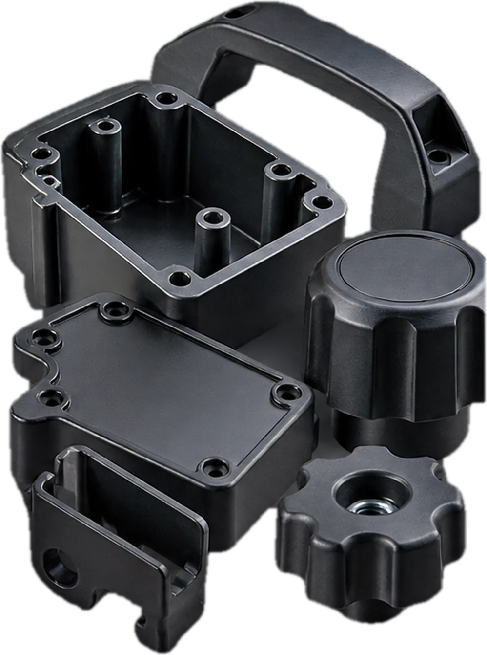 Injection-moulded plastic components: a housing and lid, a handle and two knobs